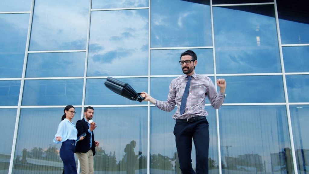Man celebrating success outside modern office building